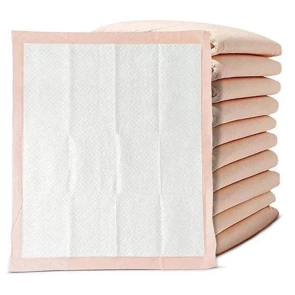 Peach underpad opened in front of a folded stack