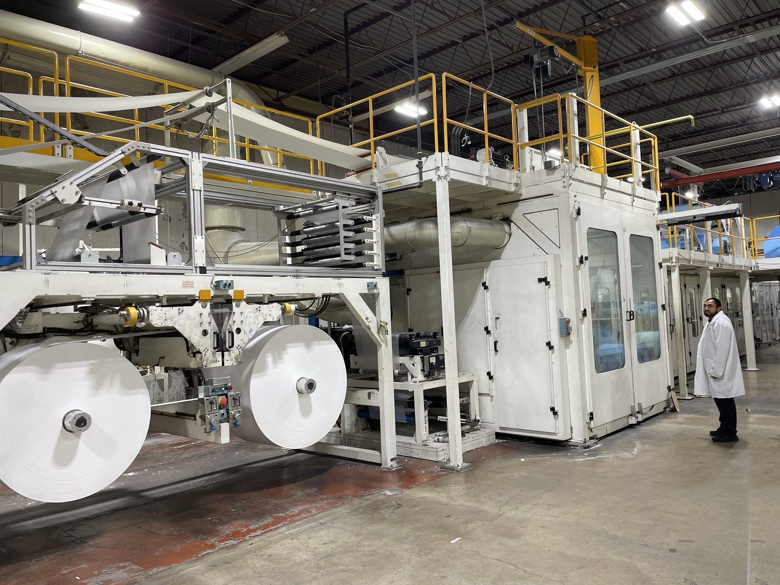 Large rolls of nonwoven material on the unwind stand of one of our production lines
